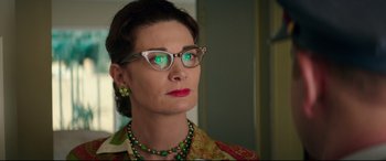 Movie still from “Suburbicon” (2017), directed by George Clooney – A woman wearing glasses and wearing a necklace; Close Up shot, Low angle