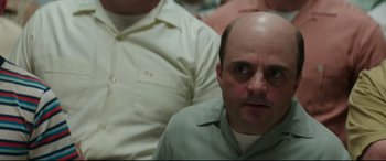 Movie still from “Suburbicon” (2017), directed by George Clooney – A man with a bald head is looking at the camera; Close Up shot, Over the shoulder angle