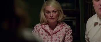 Movie still from “Suburbicon” (2017), directed by George Clooney – A woman with blonde hair wearing a pink and white floral pajamas; Close Up shot, Over the shoulder angle