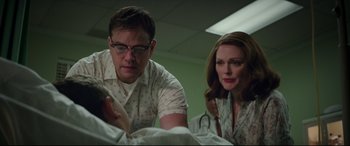 Movie still from “Suburbicon” (2017), directed by George Clooney – A man and a woman are looking at something in a room; Medium shot, Low angle