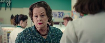 Movie still from “Suburbicon” (2017), directed by George Clooney – An older woman in a blue and green shirt; Close Up shot, Over the shoulder angle