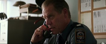 Movie still from “Suburbicon” (2017), directed by George Clooney – A person talking on a cell phone; Close Up shot, Low angle