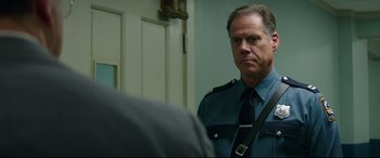 Movie still from “Suburbicon” (2017), directed by George Clooney – A man in a police uniform looking into the mirror; Close Up shot, Over the shoulder angle