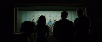 Movie still from “Suburbicon” (2017), directed by George Clooney – A group of people standing in front of a wall; Wide shot, Low angle