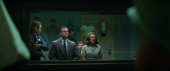 Movie still from “Suburbicon” (2017), directed by George Clooney – A group of people standing next to each other in front of a mirror; Wide shot, Low angle