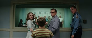 Movie still from “Suburbicon” (2017), directed by George Clooney – A man and a woman standing next to a boy; Medium shot, Low angle