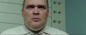 Movie still from “Suburbicon” (2017), directed by George Clooney – A man's face in front of a wall; Close Up shot, Low angle