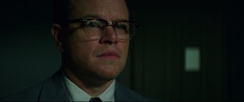 Movie still from “Suburbicon” (2017), directed by George Clooney – A person wearing a suit and glasses; Close Up shot, Low angle