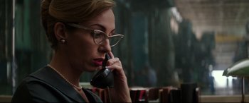 Movie still from “Suburbicon” (2017), directed by George Clooney – A woman with glasses is talking on a phone; Close Up shot, Low angle