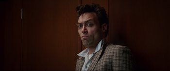 Movie still from “Suburbicon” (2017), directed by George Clooney – A person wearing a suit and tie; Close Up shot, Low angle