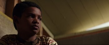 Movie still from “Suburbicon” (2017), directed by George Clooney – A young person with a striped shirt; Close Up shot, Low angle