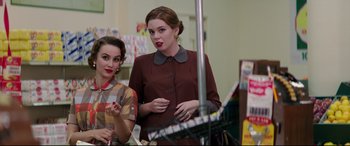 Movie still from “Suburbicon” (2017), directed by George Clooney – Two women are standing in front of a mirror; Medium shot, Over the shoulder angle