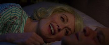 Movie still from “Suburbicon” (2017), directed by George Clooney – A woman with blonde hair is smiling for the camera; Close Up shot, Overhead angle