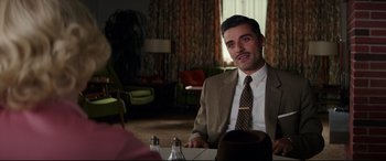 Movie still from “Suburbicon” (2017), directed by George Clooney – A man sitting at a table in front of a mirror; Medium shot, Over the shoulder angle