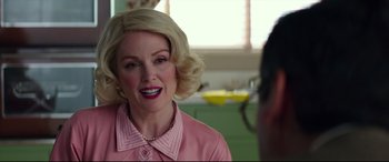 Movie still from “Suburbicon” (2017), directed by George Clooney – A woman with blonde hair wearing a pink shirt; Close Up shot, Over the shoulder angle
