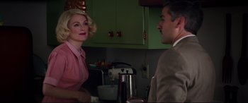 Movie still from “Suburbicon” (2017), directed by George Clooney – A man and a woman in a kitchen talking to each other; Medium shot, Over the shoulder angle