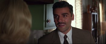 Movie still from “Suburbicon” (2017), directed by George Clooney – A person wearing a suit and tie; Close Up shot, Over the shoulder angle