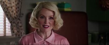 Movie still from “Suburbicon” (2017), directed by George Clooney – A woman with blonde hair wearing a pink shirt; Close Up shot, Over the shoulder angle
