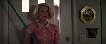 Movie still from “Suburbicon” (2017), directed by George Clooney – A woman with blonde hair wearing a pink shirt; Medium shot, Low angle