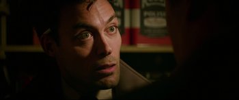 Movie still from “Suburbicon” (2017), directed by George Clooney – A man's face in a dark room; Close Up shot, Over the shoulder angle