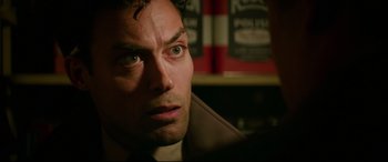 Movie still from “Suburbicon” (2017), directed by George Clooney – A man's face in front of a book shelf; Close Up shot, Over the shoulder angle