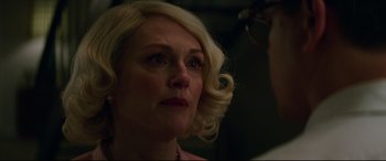 Movie still from “Suburbicon” (2017), directed by George Clooney – A woman with blonde curly hair looking up at the sky; Close Up shot, Over the shoulder angle