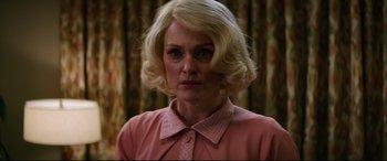 Movie still from “Suburbicon” (2017), directed by George Clooney – A woman with blonde hair wearing a pink shirt; Close Up shot, Low angle