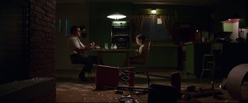 Movie still from “Suburbicon” (2017), directed by George Clooney – A man and a woman are sitting at a table; Wide shot, High angle