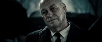 Movie still from “Sucker Punch” (2011), directed by Zack Snyder – An older man wearing a suit and a tie; Close Up shot, Low angle