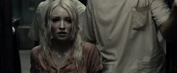 Movie still from “Sucker Punch” (2011), directed by Zack Snyder – A woman with long blonde hair wearing a brown shirt; Close Up shot, High angle