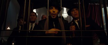 Movie still from “Sucker Punch” (2011), directed by Zack Snyder – A group of men standing next to each other in a room; Medium shot, Low angle