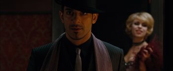 Movie still from “Sucker Punch” (2011), directed by Zack Snyder – A person wearing a hat and a tie; Close Up shot, High angle