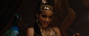 Movie still from “Sucker Punch” (2011), directed by Zack Snyder – A woman in a gold costume with a smile on her face; Close Up shot, High angle