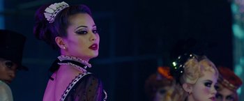 Movie still from “Sucker Punch” (2011), directed by Zack Snyder – A woman in a black dress and a black and white mask; Close Up shot, Over the shoulder angle