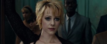 Movie still from “Sucker Punch” (2011), directed by Zack Snyder – A person with short blonde hair; Close Up shot, Over the shoulder angle