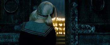 Movie still from “Sucker Punch” (2011), directed by Zack Snyder – A woman with blonde hair and a black top; Close Up shot, Over the shoulder angle