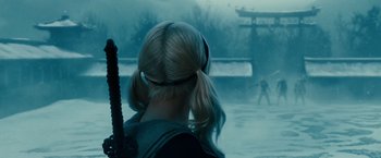 Movie still from “Sucker Punch” (2011), directed by Zack Snyder – A girl with blonde pigtails is looking at something in the distance; Close Up shot, Over the shoulder angle