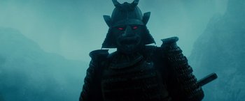 Movie still from “Sucker Punch” (2011), directed by Zack Snyder – The face of a statue of a samurai warrior; Close Up shot, Low angle