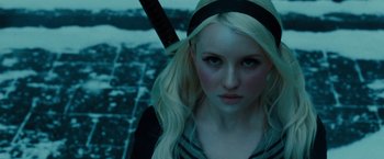 Movie still from “Sucker Punch” (2011), directed by Zack Snyder – A woman with long blonde hair wearing a black headband; Close Up shot, Low angle