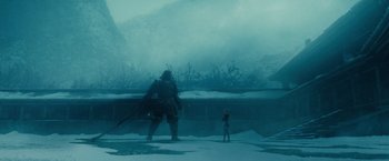Movie still from “Sucker Punch” (2011), directed by Zack Snyder – A man standing next to a woman in the snow; Extreme Wide shot, Low angle