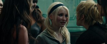 Movie still from “Sucker Punch” (2011), directed by Zack Snyder – A woman with long blonde hair wearing a black headband; Close Up shot, Over the shoulder angle