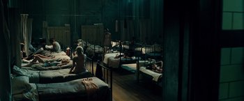 Movie still from “Sucker Punch” (2011), directed by Zack Snyder – A group of people are sleeping in a room; Wide shot, High angle
