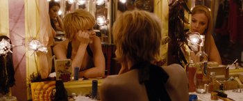 Movie still from “Sucker Punch” (2011), directed by Zack Snyder – A woman sitting in front of a mirror looking at herself in the mirror; Close Up shot, Over the shoulder angle