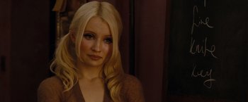 Movie still from “Sucker Punch” (2011), directed by Zack Snyder – A woman with long blonde hair wearing a brown sweater; Close Up shot, Over the shoulder angle