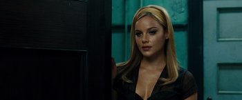Movie still from “Sucker Punch” (2011), directed by Zack Snyder – A beautiful blonde woman with long blonde hair; Close Up shot, Over the shoulder angle
