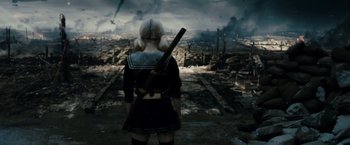 Movie still from “Sucker Punch” (2011), directed by Zack Snyder – A woman holding a rifle in a desolate area; Wide shot, High angle