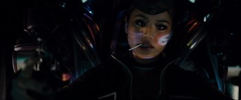 Movie still from “Sucker Punch” (2011), directed by Zack Snyder – A woman smoking a cigarette while wearing a helmet; Close Up shot, Low angle
