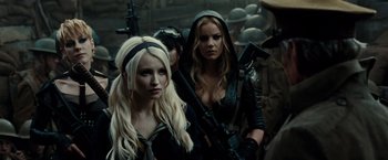 Movie still from “Sucker Punch” (2011), directed by Zack Snyder – Two beautiful women with blonde hair holding guns; Close Up shot, Over the shoulder angle
