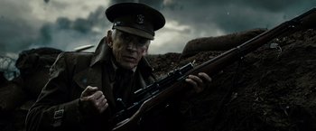 Movie still from “Sucker Punch” (2011), directed by Zack Snyder – An old man in uniform holding a rifle; Close Up shot, Low angle