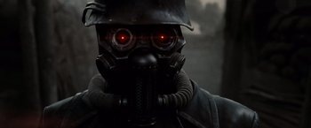 Movie still from “Sucker Punch” (2011), directed by Zack Snyder – A person wearing a gas mask and a helmet; Close Up shot, Low angle